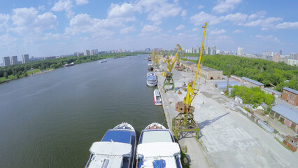  Several vessels and cranes in city river port at summer sunny day. Aerial view videoframe
