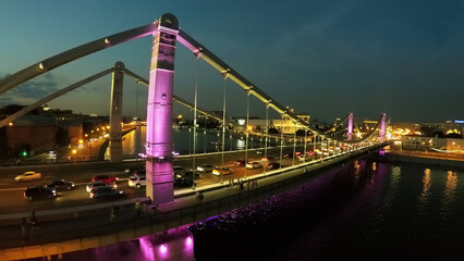  Cars ride by Crimean bridge and embankment at summer evening. Aerial view