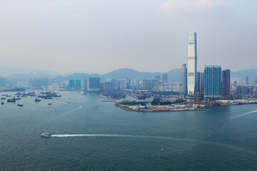 Skyscraper One Island East Centre and sea shore in business area in mist in Hong Kong, China, view from China Merchants Tower