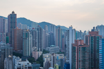 Fototapeta na wymiar Skyscrapers and modern tall residential buildings and mountains in Hong Kong, China, view from China Merchants Tower
