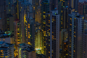 Skyscrapers and modern tall residential buildings in Hong Kong, China at night, view from Queen Garden