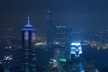 Night high Center tower with illumination and river in Hong Kong, China, view from Queen Garden