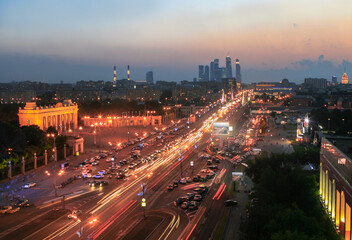 Fototapeta na wymiar Krymsky Val Street, traffic, entrance arch in Gorky Park in Moscow night, Russia