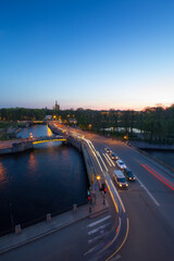Panteleymonovsky bridge with cars, channels, park at evening in St. Petersburg, Russia
