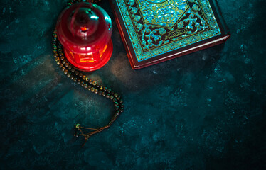 Ramadan Kareem and Eid Mubarak background, Islamic prayer concept image, Quran with tasbih and lantern on t he table