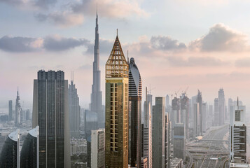 Fototapeta na wymiar DUBAI, UAE - JAN 8, 2017: Burj Khalifa, Rose Rayhaan by Rotana, Ahmed Abdul Rahim Al Attar Tower, Sheikh Zayed Highway