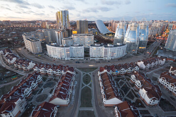 Residential area with tall buildings and cottages in Krasnogorsk, Russia at evening