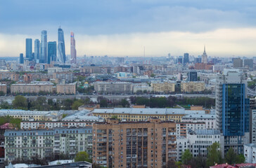 Roofs of buildings in sleeping area and skyscrapers in Moscow, Russia