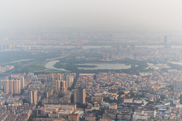 Fototapeta na wymiar Guangzhou city, Zhujiang river with bridge in fog, China, aerial view