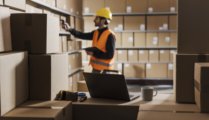 Warehouse clerk scanning labels on packages - 755747091