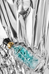 Perfume on foil background