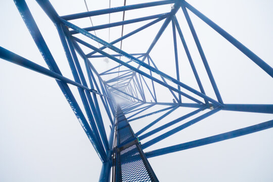 Inside top of crane on skyscraper under construction in clouds