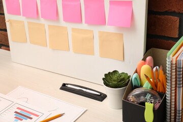 Business process planning and optimization. Workplace with colorful paper notes and other stationery on table