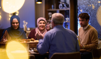 A modern and traditional European Islamic family comes together for iftar in a contemporary...