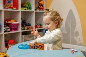 Toddler Playing with Toy Truck at Home