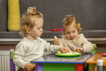 Toddlers Sharing Snack Time at Play Table