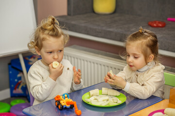 Toddlers Sharing Snack Time at Play Table