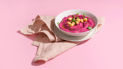 Beetroot hummus on pink background