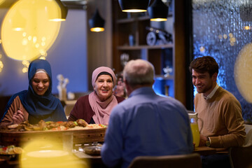 A modern and traditional European Islamic family comes together for iftar in a contemporary...