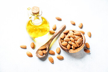 Almond nuts and almond oil at white background. Healthy fat, omega 3 sources.