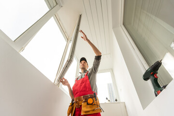 male industrial builder worker at window installation in building construction site