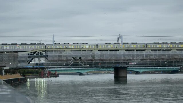 sumida river view with public train transportation on railway track crossing river in the city of Tokyo in Japan