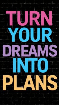 A motivational quote 'Turn Your Dreams Into Plans' in colorful letters against a black brick wall background