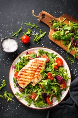 Foto op Aluminium Healthy food. Chicken steak BBQ grill meat with fresh salad on black background. Top view. © nadianb