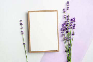 Blank wedding invitation card mockup with fresh lavender flowers, top view with copy space