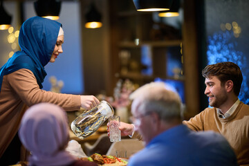 A modern and traditional European Islamic family comes together for iftar in a contemporary...