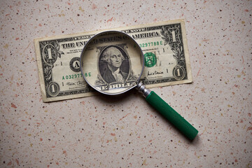 US dollar, magnifying glass