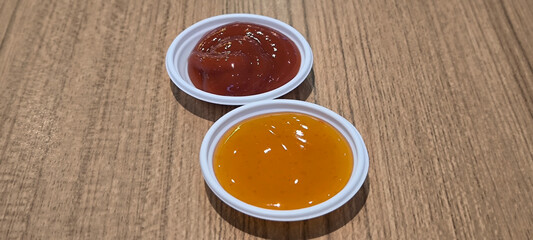 Sauce in a white plastic cup on the table