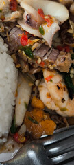 Seafood stir-fried with chilli in a rice dish. spicy seafood
