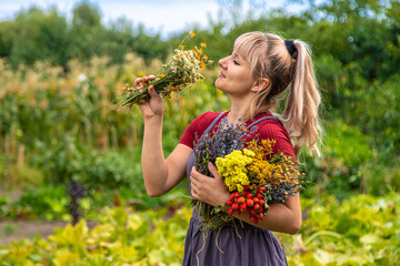 A woman holds medicinal herbs in her hands. Selective focus.