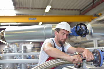 Mechanics repair a machine in a modern industrial plant - professionell occupation job
