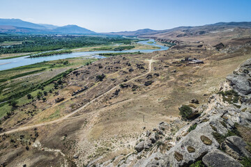 Aerial view from Uplistsikhe ancient rock-hewn town with Kura river, Georgia