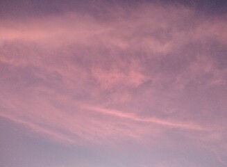 Cloudscape, Colored Clouds at Sunset near the Ocean on a Blue Sky