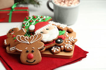 Fototapeta premium Tasty homemade Christmas cookies on white wooden table. Space for text