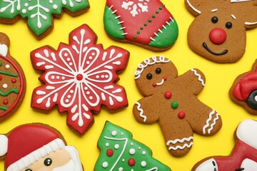 Fototapeta na wymiar Different tasty Christmas cookies on yellow background, flat lay
