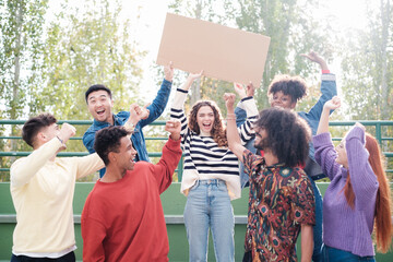 Group of young fans carrying a banner to support their successes. Concept: lifestyle, advertisement