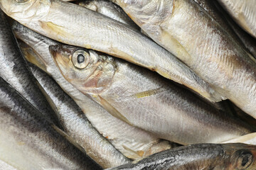 Fresh raw sprats as background, top view
