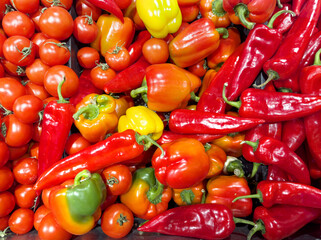 buying vegetables ( peppers,  tomatoes) at the market