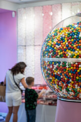 mother and kid buying sweet candy and bubble gum at sweet store, family at sugar food shopping