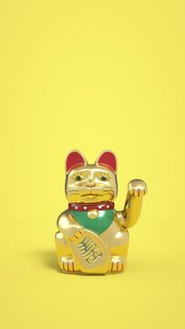 Maneki-neko cat waving his paw on yellow background. Gold fortune cats wave paws vertical animation. Maneki neko Japanese and Chinese figure fortune and luck cat.