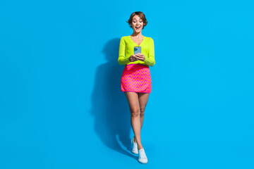 Full body size photo of amazed young lady in shirt mini skirt using smartphone found nice deal...