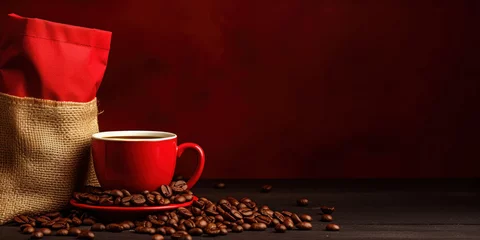 Tuinposter Red cup of hot coffee with a bag and scattered coffee beans on a wooden table. © OleksandrZastrozhnov
