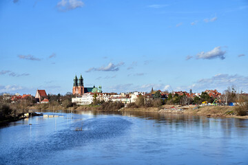 Historic buildings and towers of the gothic cathedral on the Warta River. in the city of Poznan - obrazy, fototapety, plakaty