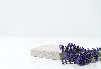 Elegant product presentation scene with porous pedestal and lavender sprig