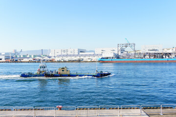 Fototapeta na wymiar Sailing ship through Osaka port , Marine cargo, large port city and commercial center on the Japanese island of Honshu, Osaka, Japan.
