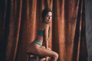 Fotobehang No retouch photo of gorgeous sporty young girl in underwear khaki lingerie posing sitting stool feminine isolated on brown color background © deagreez
